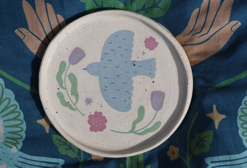 Plate with bird and plant decoration by Shannon McQuade