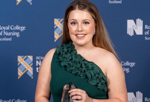 Robyn Oliphant in front of awards background