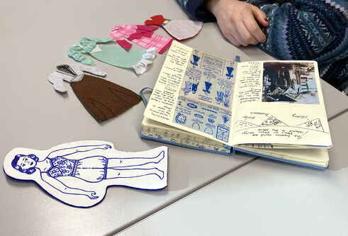 A selection of brochures, catalogues alongside some of the newly-created artwork from the exhibition