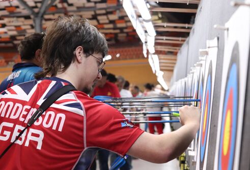 William Anderson at the European Indoor Championships  taking an arrow out archery board