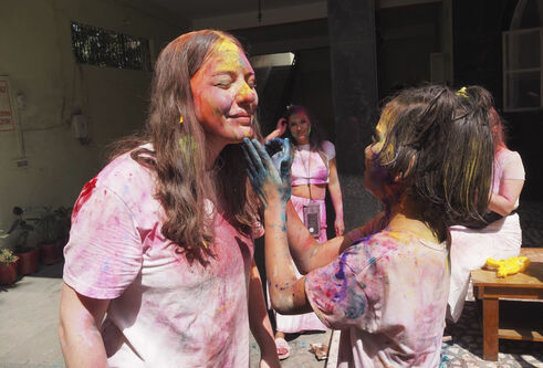 Gracie Boyd covered in colourful paint powder.