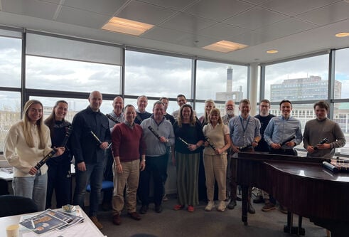 A group of business leaders posing for the camera after receiving their course certificates