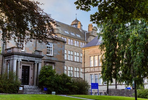 An exterior shot of the School of Business building at dusk