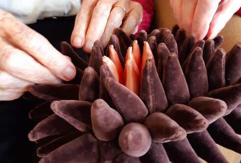 hands feeling a soft sculpture by Karen Scopa