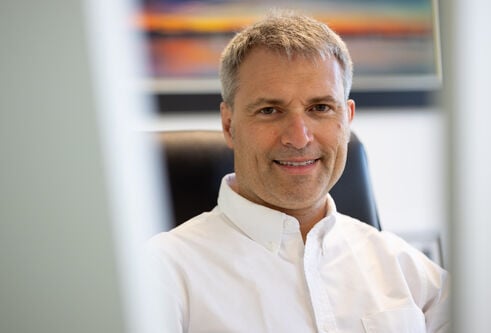 Professor Alessio Ciulii, wearing a white, open-collared shirt.