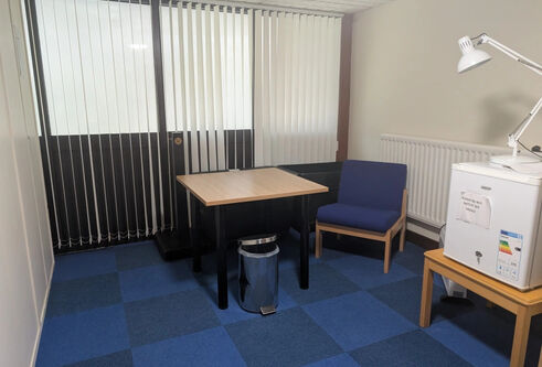 Tower builidng quiet room in the basement has a small table and chair