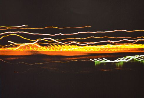 photo featuring an abstracted cityscape at night with light trails