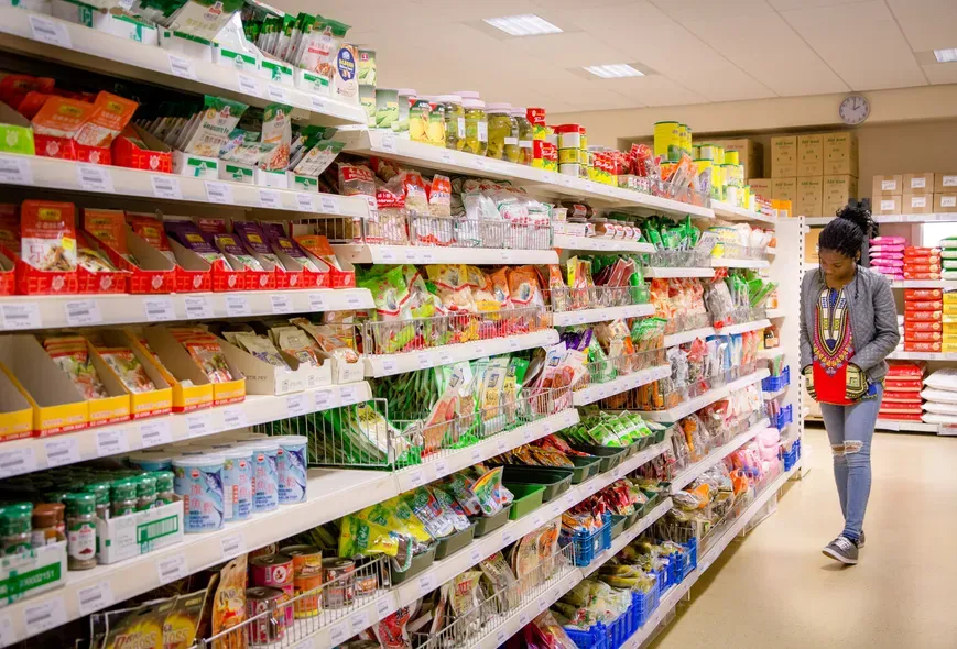 Student in supermarket aisle