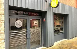 a grey shop front with double glass doors