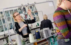 Student using a knitting machine in DJCAD