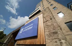 Tower Building with the University of Dundee logo and blue skies above