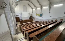 Carnelley Large Lecture Theatre a view from the top of the theatre showing rows of wooden benches and ornate ceiling