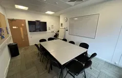 Dalhousie 2S01 - one table set up in an oblong shape with chairs. A white board and tv screen on the wall
