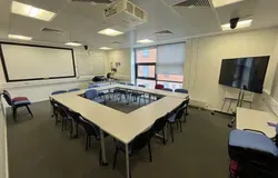 Dalhousie 2S02 - tables and chairs with a mobile tv screen and white screen at far wall