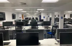 IT Suite in Tower Basement showing rows of desks with computer screens
