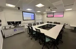 Dalhousie1G15 - white table set in a square with tv screen on the wall