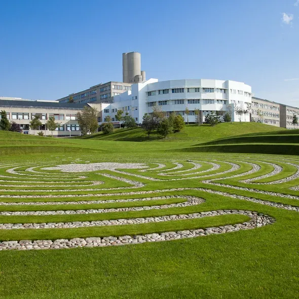 white building behind green grass