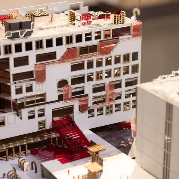 A model of a building showing several windows and divided sections on the rooftop as part of the Degree Show 2025 exhibition