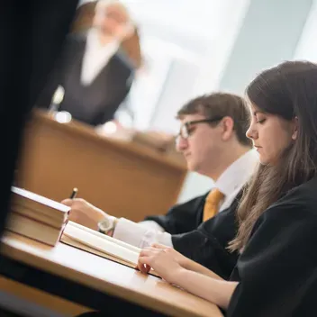 Law students looking at documents in the mooting room
