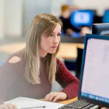 girl sitting working at computer