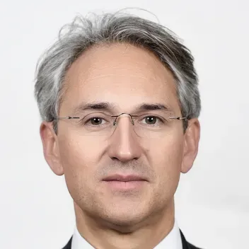 Portrait of August Reinisch against a white background.