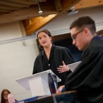 Graduate stood talking at the podium 