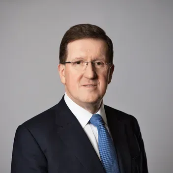Lord Robertson in black suit and blue tie
