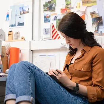 student sitting by laptop