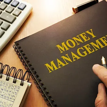 A notebook with Money Management on the front cover