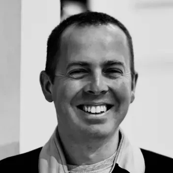Black and white image of Robert Jackson smiling.
