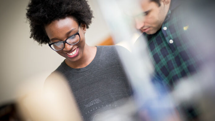 Students smiling in a workshop