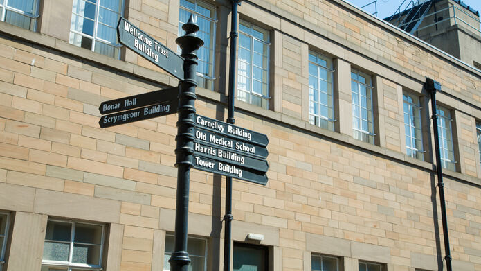 directional signpost outside the Ewing Building