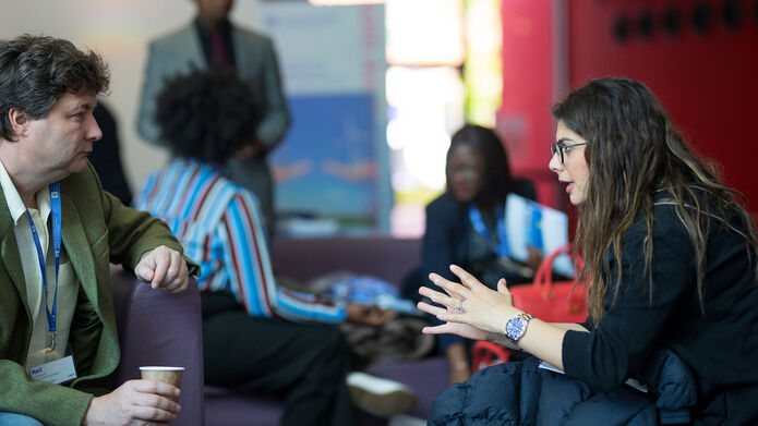 two people sitting and talking