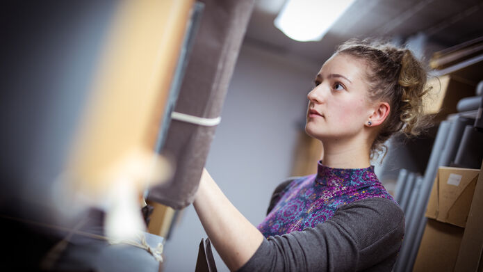 a student looking for a book in a library