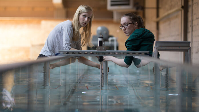 Engineering students using water tank
