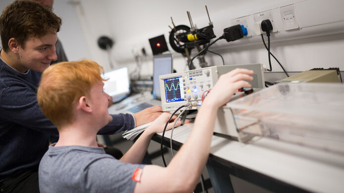 Physics students in a lab