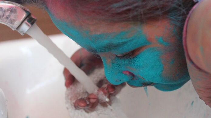 Indian girl with blue powder on face for special event