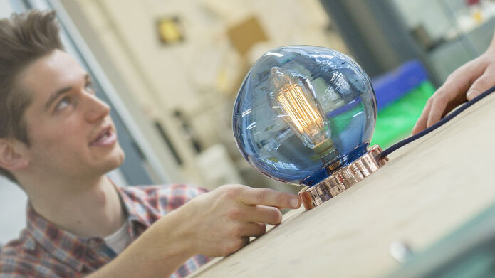 Student with large blue light bulb