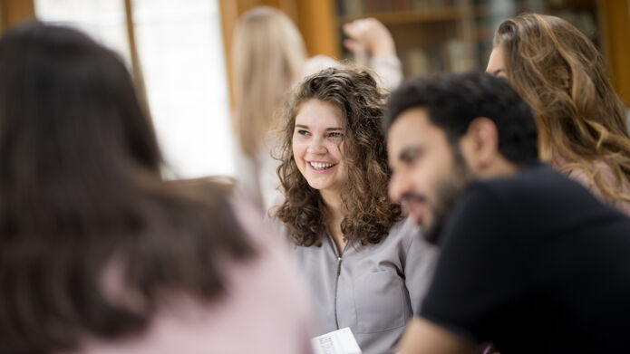 Students together round a table
