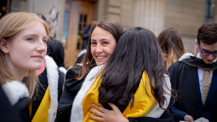 graduating students hugging