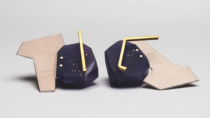 Blue earrings on a grey background