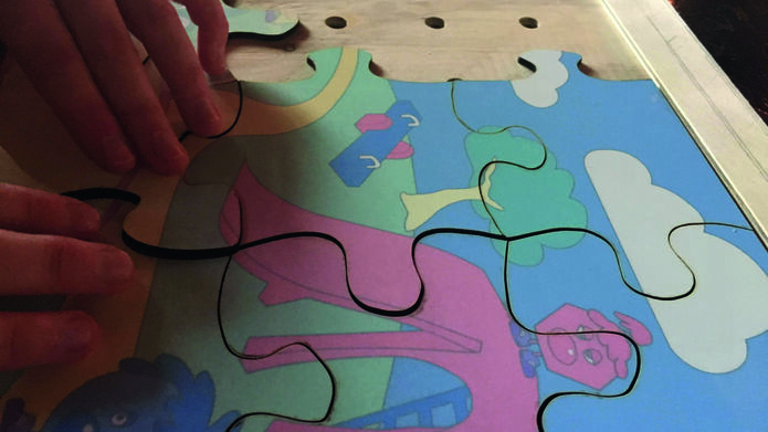 brightly coloured jigsaw in wooden tray