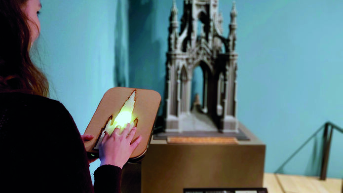 a person drawing a model of a monument