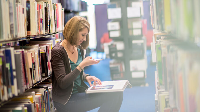 student in library