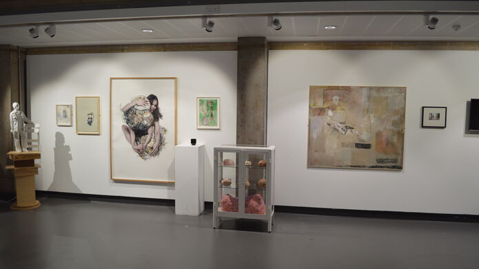 a wall in a gallery showing various images for an open day