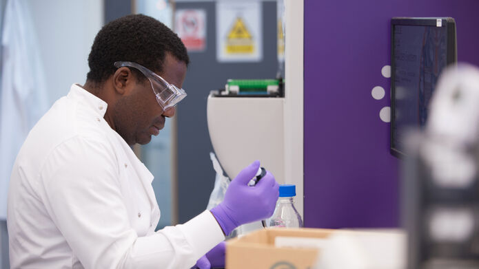 scientist in lab holding a syringe