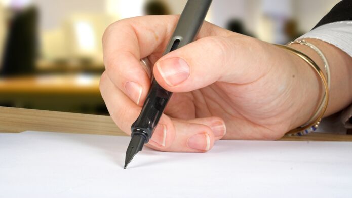 Image of someone writing a cover letter
