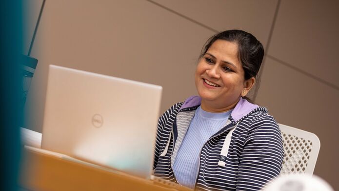 Madhavi Dubey sitting in front of a laptop