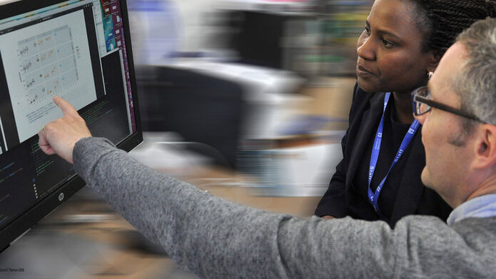 Two researchers looking at a computer screen