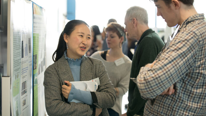 female student showing posters